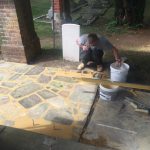 workman laying paving for the seat