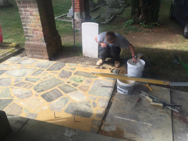 workman laying paving for the seat